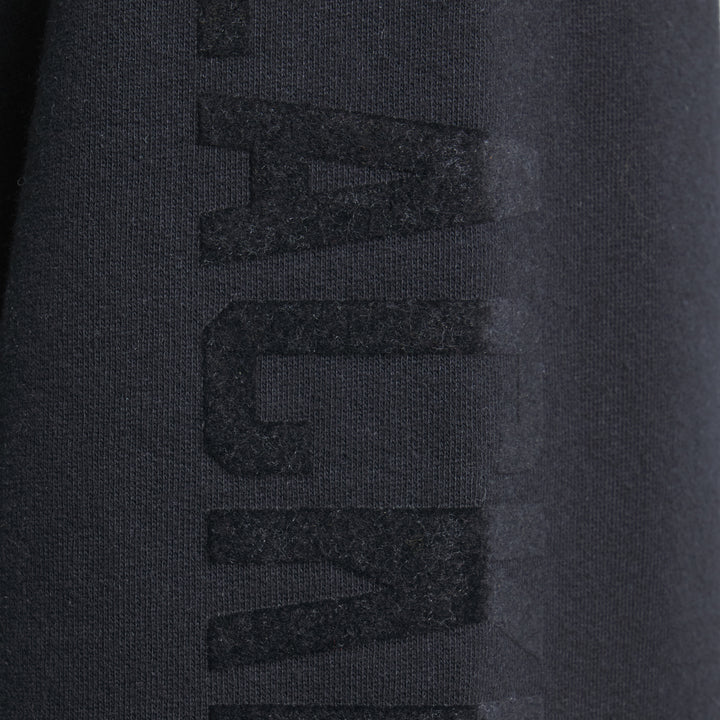black Todd Snyder x Chicago Blackhawks in partnership with Fanatics hoodie with vintage logo on front and wordmark on left sleeve - on figure sleeve detail image