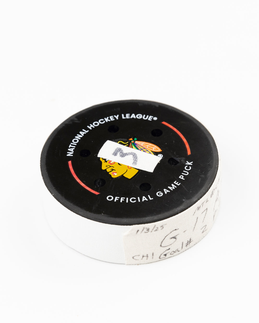 official Chicago Blackhawks game used hockey goal puck scored by player Nick Foligno against Montreal Canadiens on January 3, 2025 - front angle lay flat
