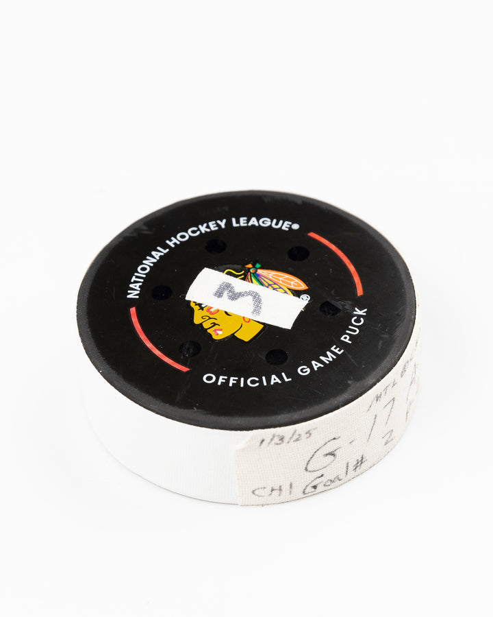 official Chicago Blackhawks game used hockey goal puck scored by player Nick Foligno against Montreal Canadiens on January 3, 2025 - front angle lay flat