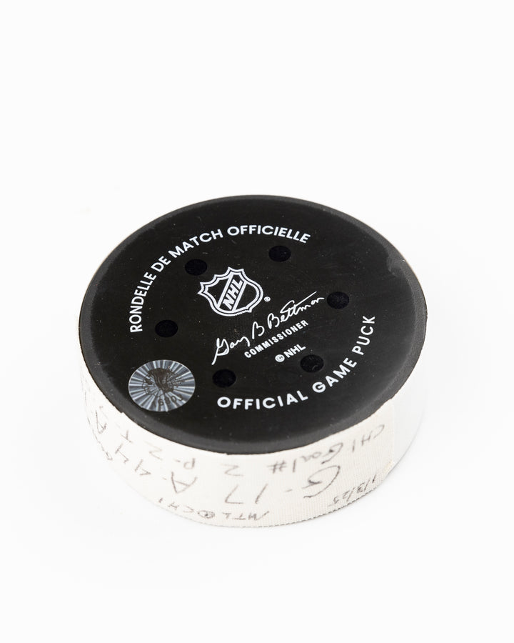 official Chicago Blackhawks game used hockey goal puck scored by player Nick Foligno against Montreal Canadiens on January 3, 2025 - back angle lay flat