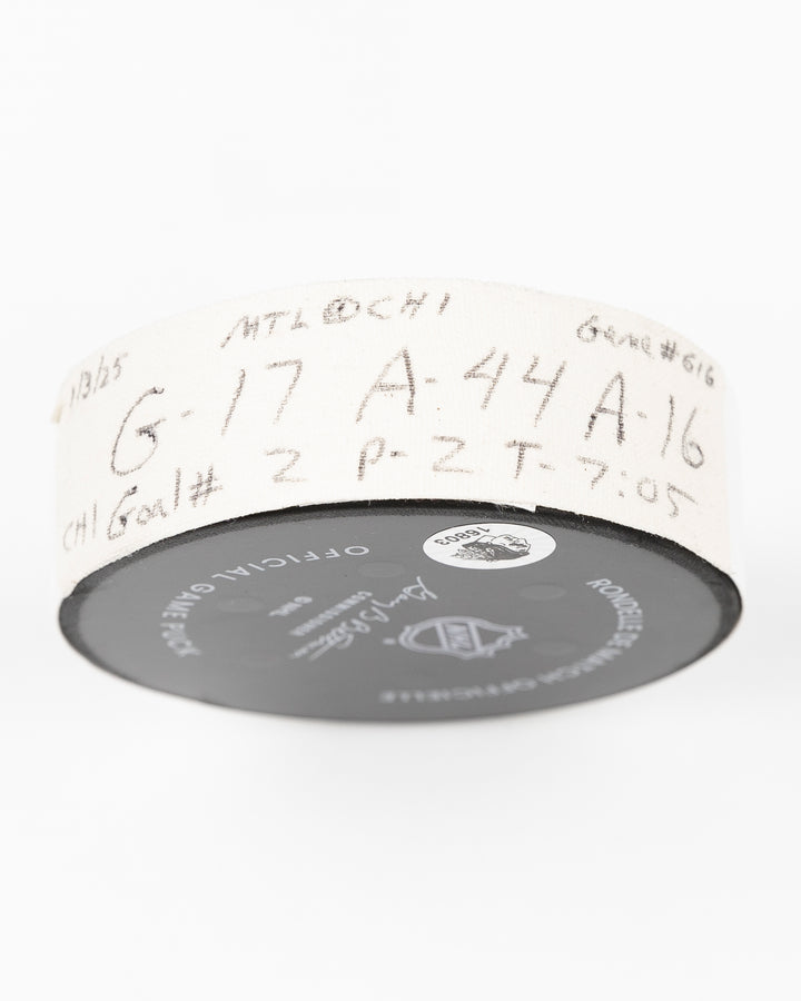 official Chicago Blackhawks game used hockey goal puck scored by player Nick Foligno against Montreal Canadiens on January 3, 2025 - tape detail lay flat