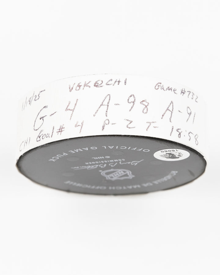 official Chicago Blackhawks game used goal hockey puck scored by Seth Jones against the Vegas Golden Knights on January 18, 2025 - tape detail lay flat