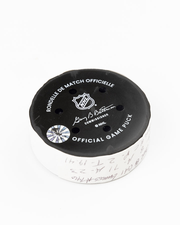 official Chicago Blackhawks game used goal puck scored by Ryan Donato against the Carolina Hurricanes on January 20, 2025 - back angle lay flat