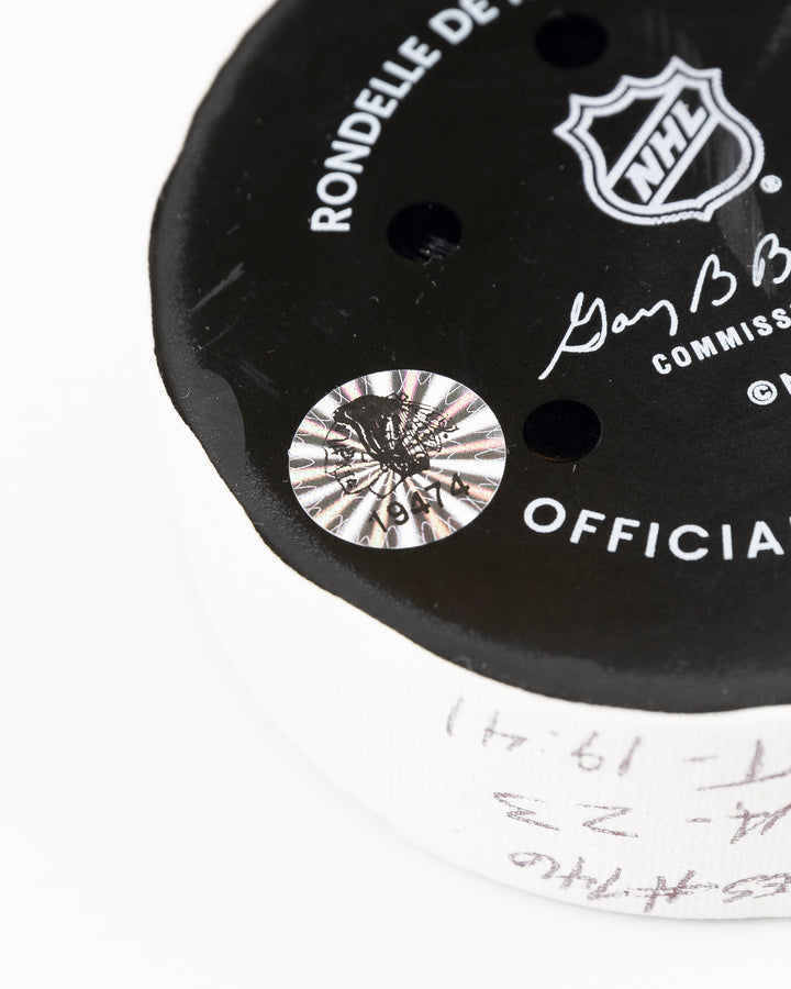 official Chicago Blackhawks game used goal puck scored by Ryan Donato against the Carolina Hurricanes on January 20, 2025 - hologram sticker detail lay flat