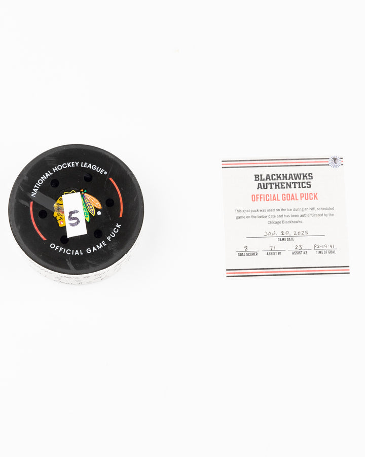 official Chicago Blackhawks game used goal puck scored by Ryan Donato against the Carolina Hurricanes on January 20, 2025 - front lay flat of puck and certificate