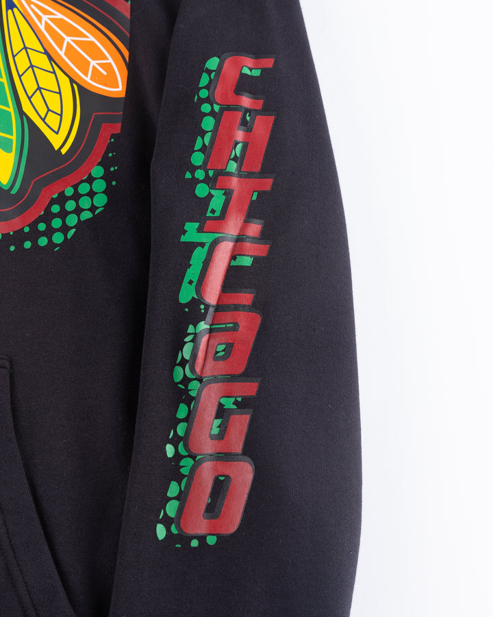 black Mitchell &amp; Ness hoodie with Chicago Blackhawks primary logo across front and Chicago wordmark on left arm - detail arm lay flat