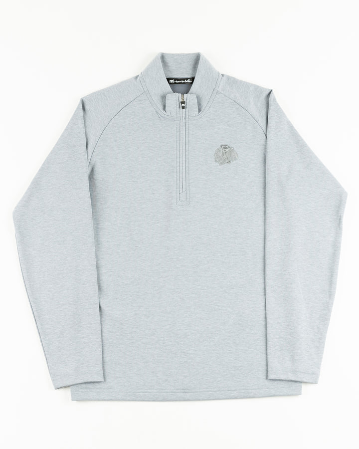 heather grey TravisMathew quarter zip with Chicago Blackhawks primary logo on left chest - front lay flat