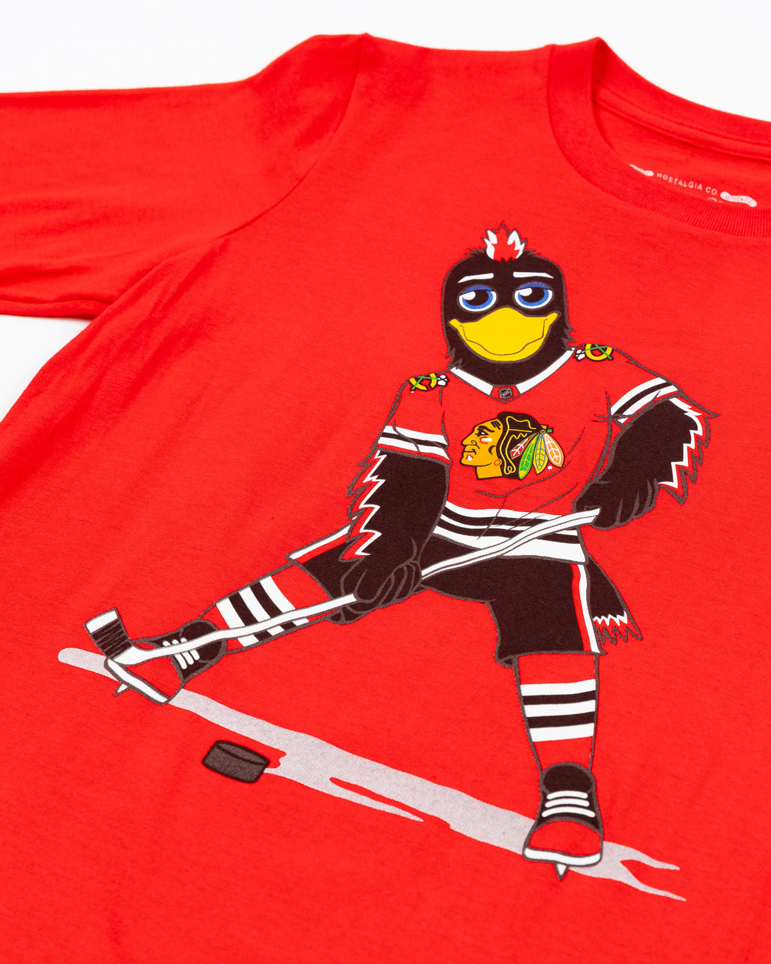 red Mitchell &amp; Ness youth short sleeve tee with Chicago Blackhawks mascot Tommy Hawk on front - detail lay flat