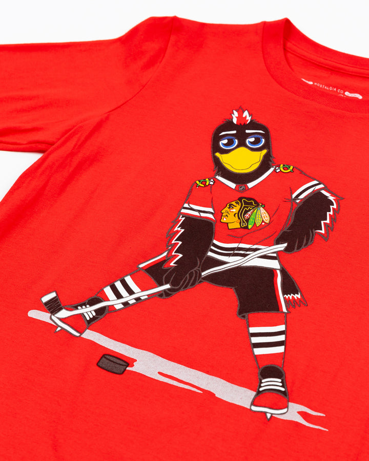 red Mitchell &amp; Ness youth short sleeve tee with Chicago Blackhawks mascot Tommy Hawk on front - detail lay flat