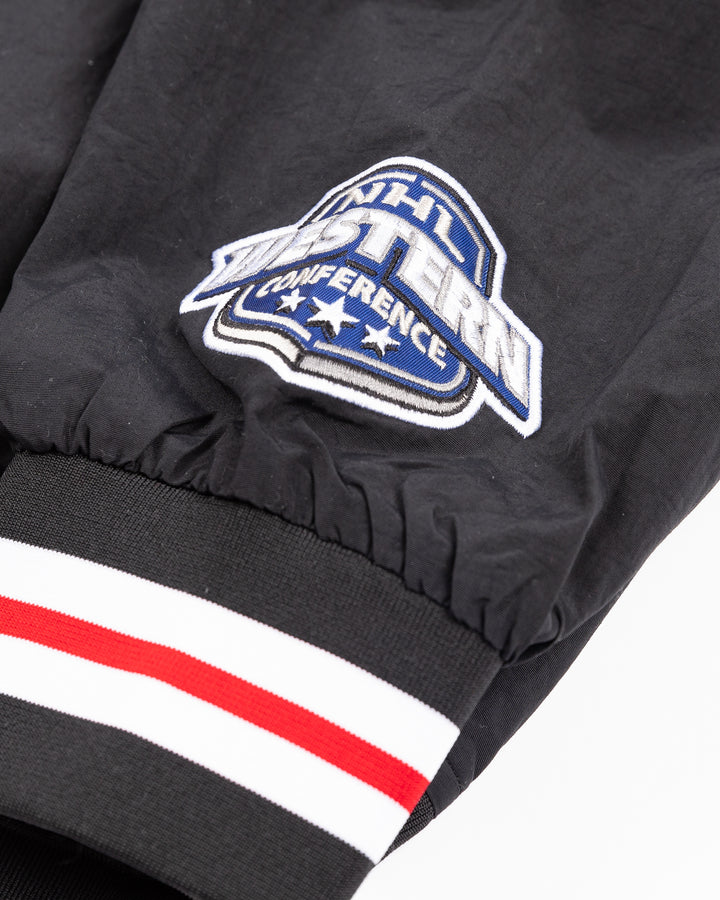 black Mitchell &amp; Ness pullover windbreaker with Chicago Blackhawks secondary logo on front and primary logo on right shoulder and NHL Western Conference on left cuff - cuff detail lay flat