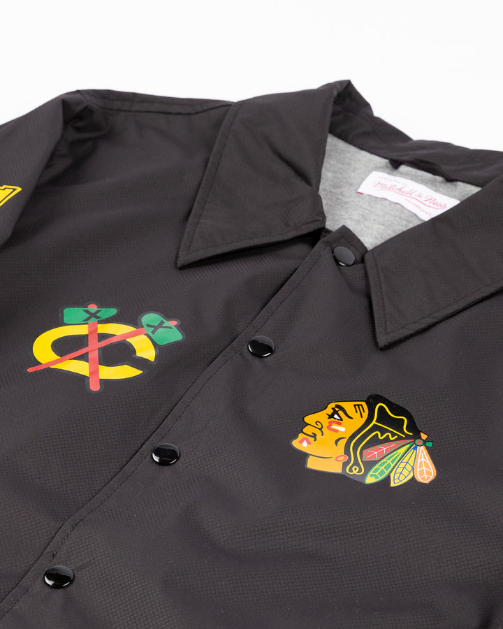 black Mitchell &amp; Ness coaches jacket with Chicago Blackhawks secondary logo on right chest and primary logo on left chest and wordmark down right sleeve - front detail lay flat