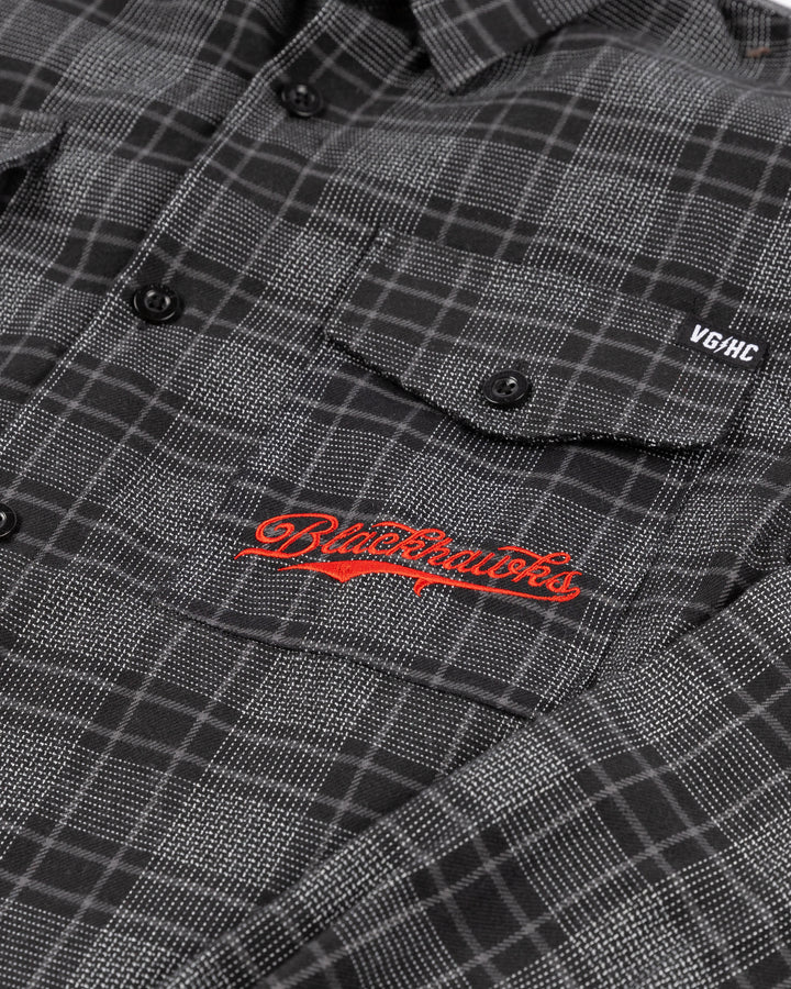 black VGHC flannel shirt with Chicago Blackhawks script embroidered in red on left chest pocket and black and white secondary logo on back yoke - front detail lay flat