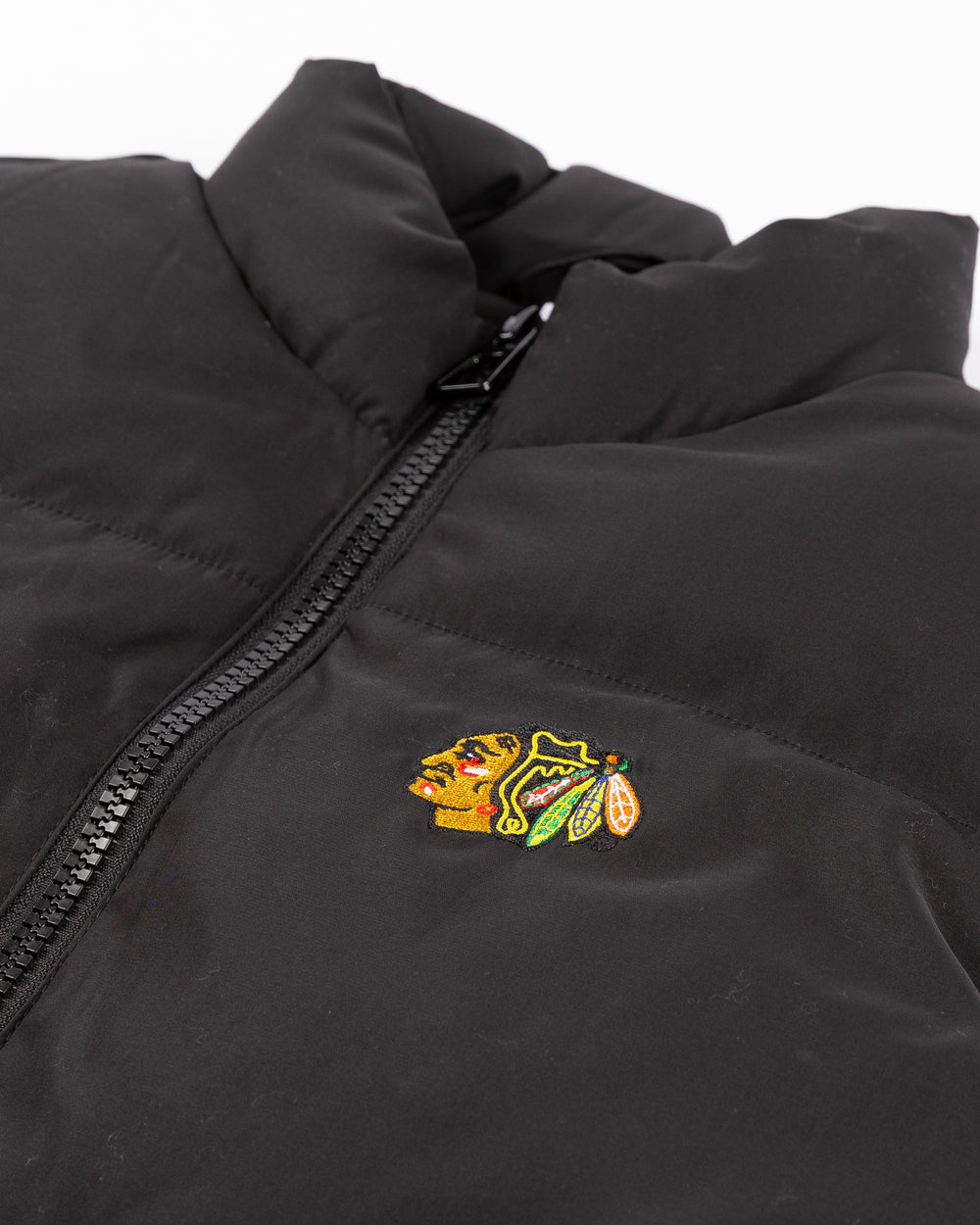 black Zoozatz puffer vest with embroidered Chicago Blackhawks primary logo on left chest - front detail lay flat