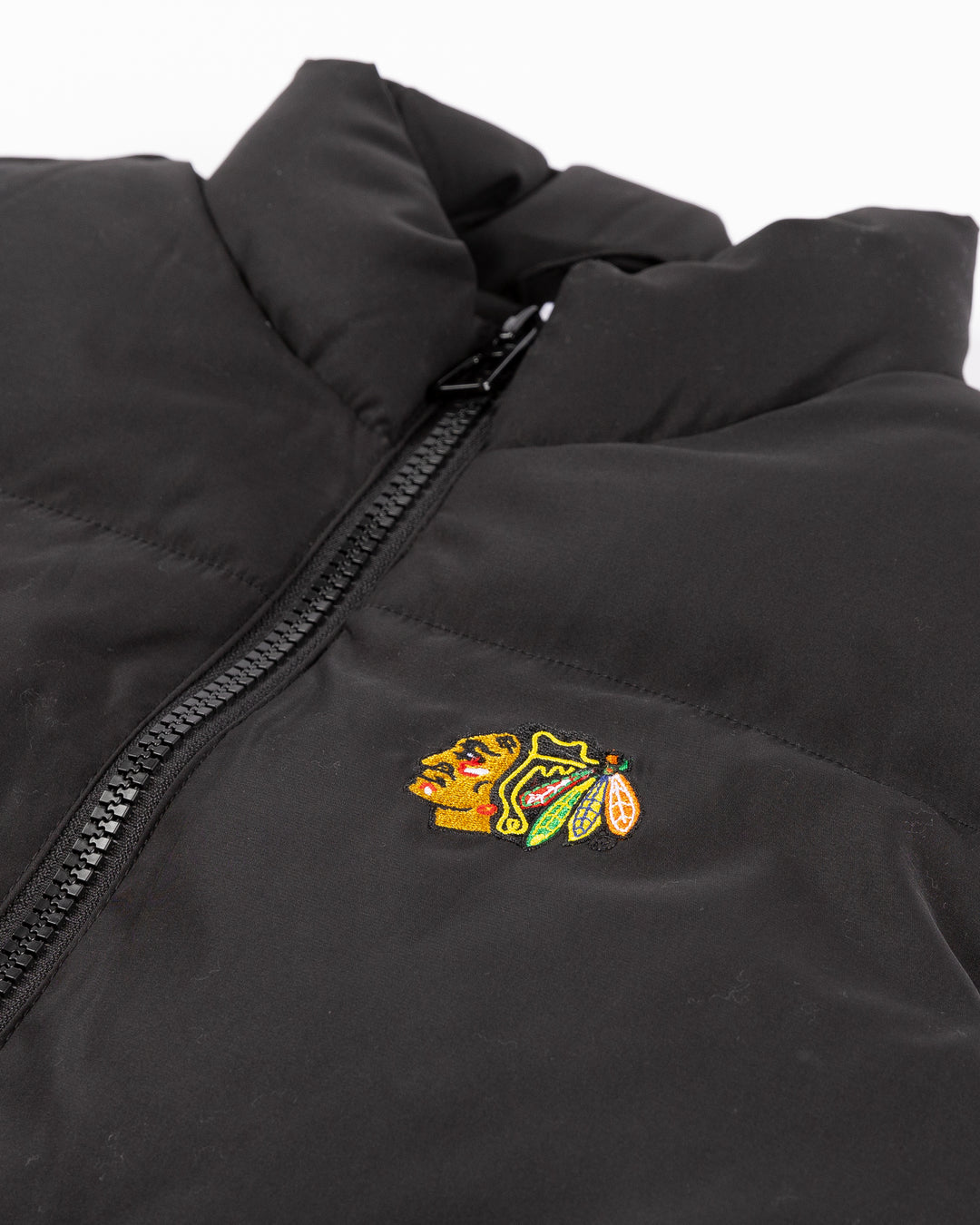 black Zoozatz puffer vest with embroidered Chicago Blackhawks primary logo on left chest - front detail lay flat