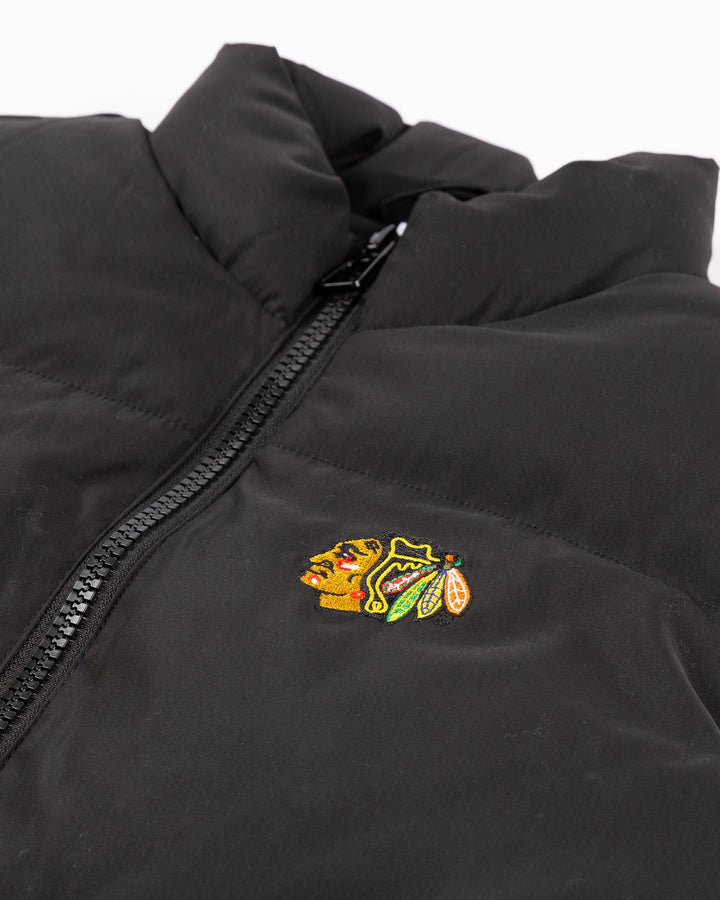 black Zoozatz puffer vest with embroidered Chicago Blackhawks primary logo on left chest - front detail lay flat