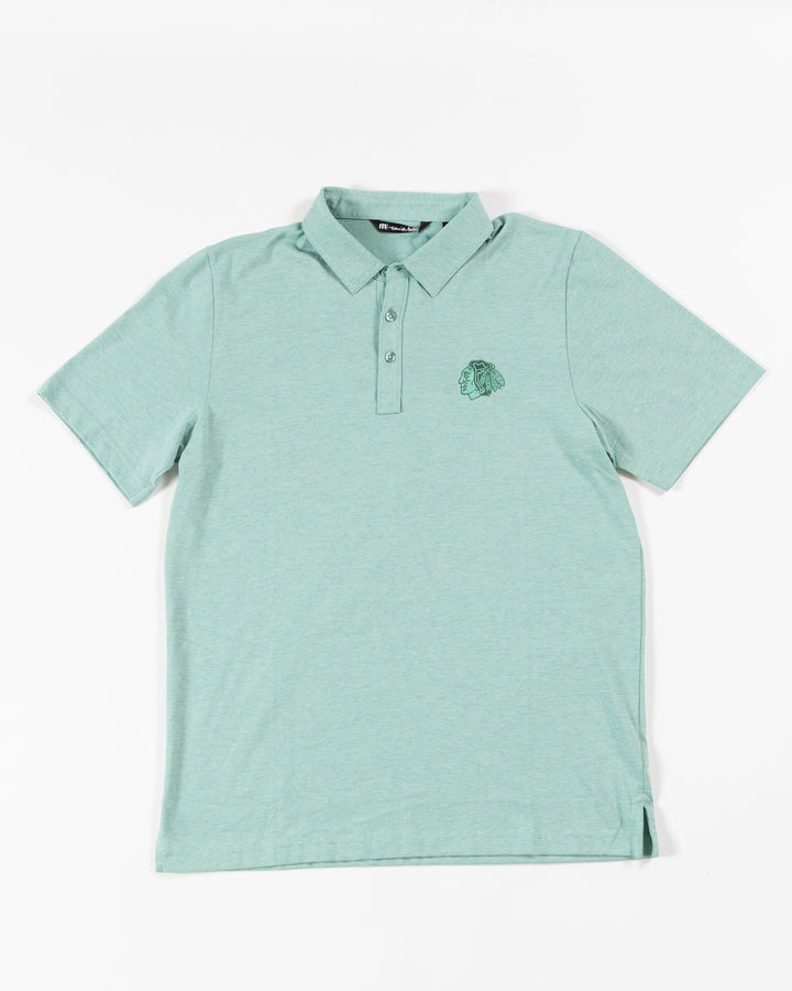TravisMathew Chicago Blackhawks green polo with embroidered tonal primary logo - front lay flat